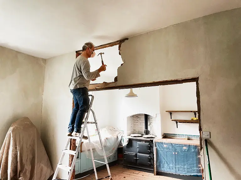 Man knocking an internal wall down